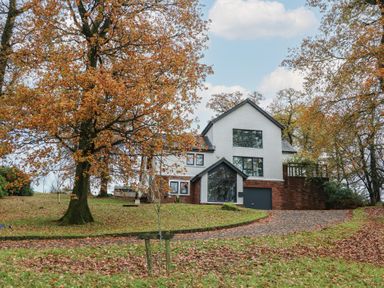 A house surrounded by trees and grass at Chapel Hill in Catlowdy