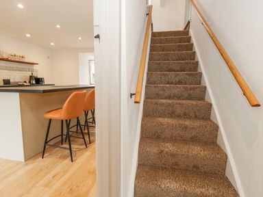 A staircase leading to an upper floor at Long Barn in Burton Bradstock