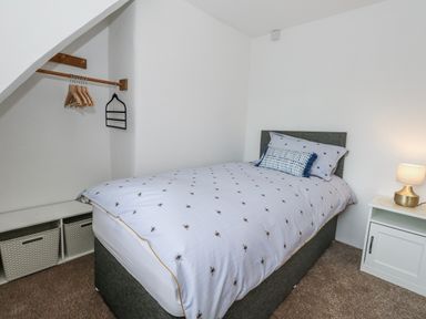 A bedroom with a bed and storage at Long Barn in Burton Bradstock
