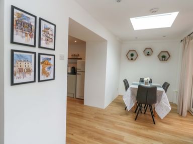 A dining room with a table and chairs at Long Barn in Burton Bradstock
