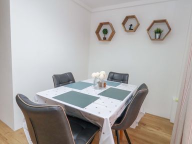 A dining room with a table and chairs at Long Barn in Burton Bradstock