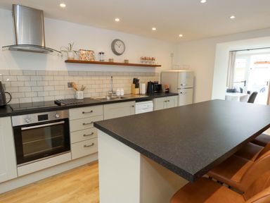 A kitchen with appliances and countertop at Long Barn in Burton Bradstock
