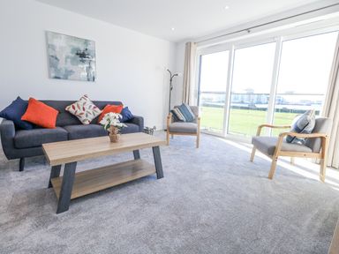A living room with a sofa and coffee table at Seafern House 36B in Poole