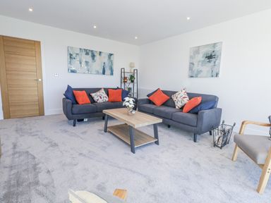 A living room with sofas and a coffee table at Seafern House 36B in Poole