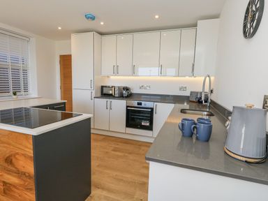 A kitchen with cabinets, an oven, and a sink at Seafern House 36B in Poole