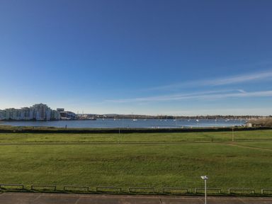 A view of buildings and water with boats at Seafern House 36B Poole