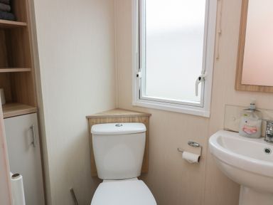 A bathroom with a toilet and sink at Peaceful in Stranraer