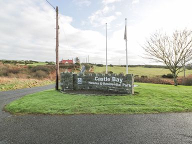 A sign for Castle Bay Holiday & Residential Park at Peaceful in Stranraer