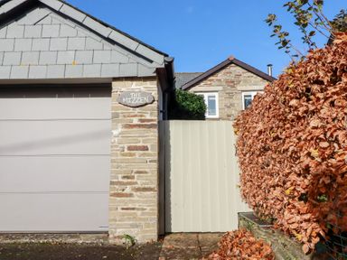 The exterior of a property with a garage and a gate at The Mizzen in St Endellion near Port Isaac