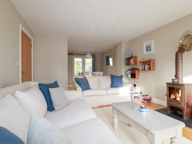 A living room with a sofa and coffee table at The Mizzen St Endellion near Port Isaac