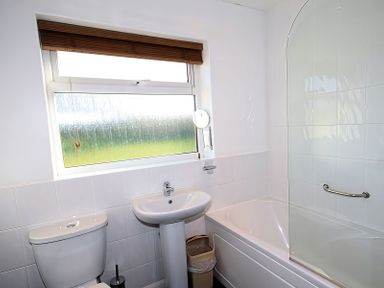 A bathroom with sink, toilet, and bathtub at Badgers Cliff in Polzeath