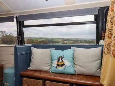 A snug with a bench and cushions at The Bus on the Hill