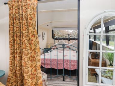 A bedroom with a bed and television at The Bus on the Hill