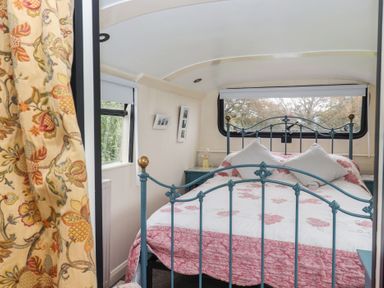 A bedroom with a bed and window at The Bus on the Hill