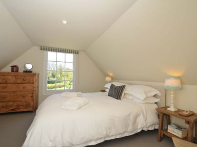 A bedroom with a bed and a dresser at Copper Mine Cottage Trelill near Port Isaac