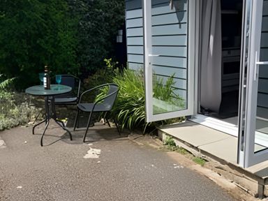 An outdoor seating area with a table and chairs at The Nook 