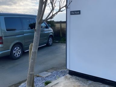 A van parked beside The Nook at The Nook 