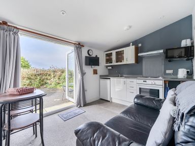 A kitchen with a seating area at The Nook in Praa Sands
