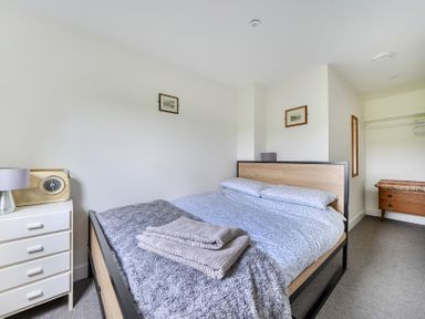 A bedroom with a bed and dresser at The Nook in Praa Sands