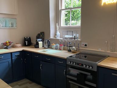 A kitchen with various appliances and a fruit bowl at High Dyke Cottage