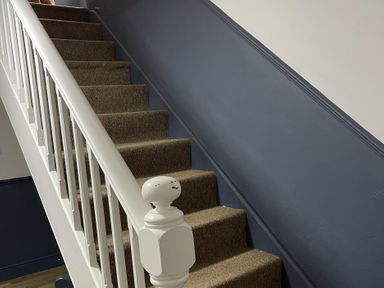 A staircase with carpet and a handrail at High Dyke Cottage 