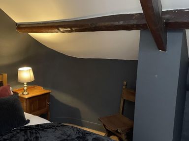 A bedroom with a bed and nightstand at High Dyke Cottage