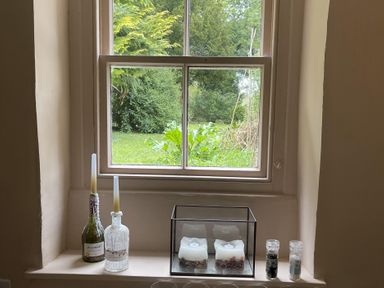 A window with candles and bottles at High Dyke Cottage