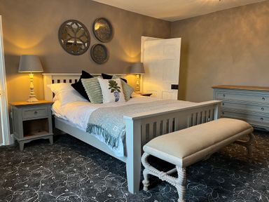 A bedroom with a bed and nightstand at ASH HOUSE in Wincanton