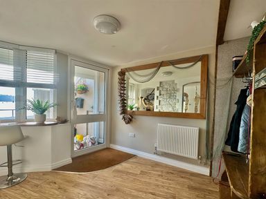 A hallway with a mirror and coat rack at 