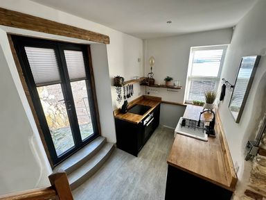 A kitchen with a wooden countertop and appliances at The Old Barn in Manchester