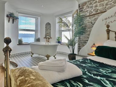 A bathroom with a bathtub and windows at the property