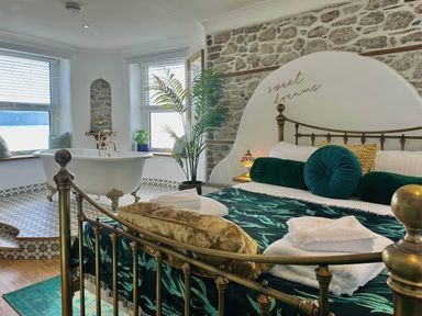 A bedroom with a bed and bathtub at 