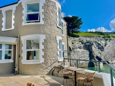 An outdoor area with seating and a view at Seafront Cottage