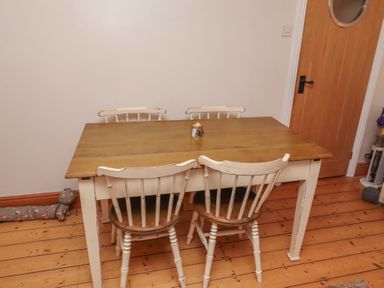 A table with chairs and a candle at Corner Cottage Seahouses