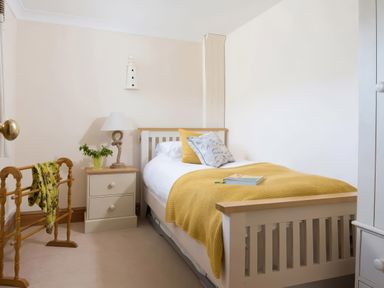 A bedroom with a single bed and nightstand at The Granary near St Merryn
