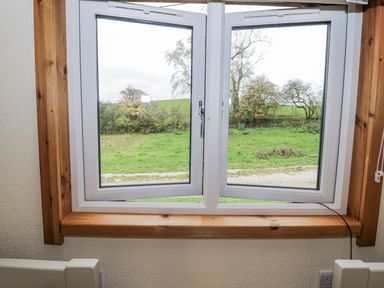 A window with a view of greenery at Willow Lodge in Admaston near Abbots Bromley