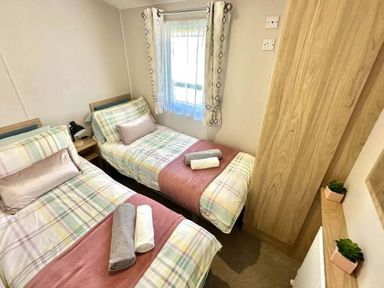 A bedroom with two beds and a window at the property in location