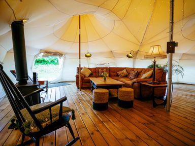 A living area with a sofa and coffee table in a tent