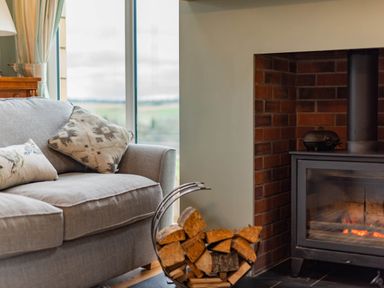 A living room with a sofa and fireplace at The Old Barn in Manchester