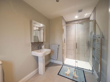 A bathroom with a shower and sink at The Old Barn in Manchester