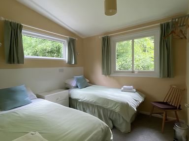 A bedroom with two beds and a window at Baillie Chalet