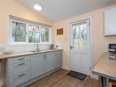 A kitchen with cabinets and a sink at Kilninver Chalet 