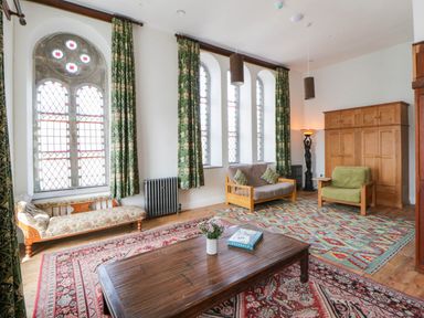 A living room with a sofa and coffee table at Capel Llani in Llanidloes