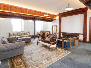 A living room with a pool table and seating area at Capel Llani Llanidloes