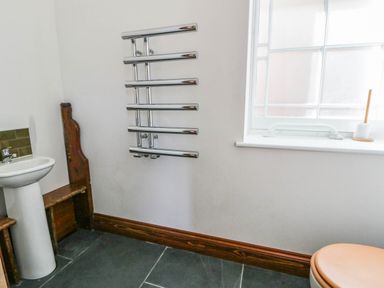 A bathroom with a sink and towel radiator at Capel Llani Llanidloes