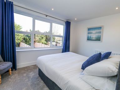A bedroom with a bed and window at Sea Fern House - 36 in Poole