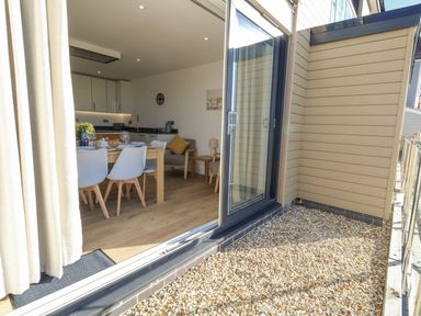 Dining area with table and chairs at Sea Fern House - 36 in Poole