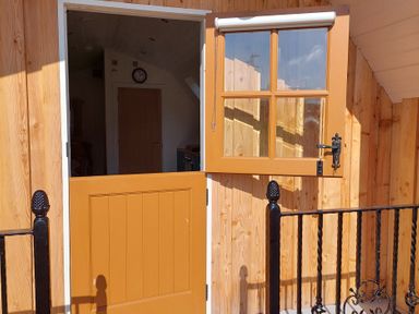 An entrance door with a clock visible at the property in 