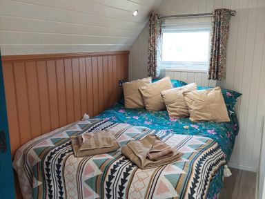 A bedroom with a bed and pillows at The Old Barn in Manchester