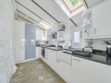 A kitchen with appliances and cabinets at Bwthyn Nain in Harlech